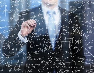 A business person is writing down math formulas on the glass screen in the evening modern panoramic office.